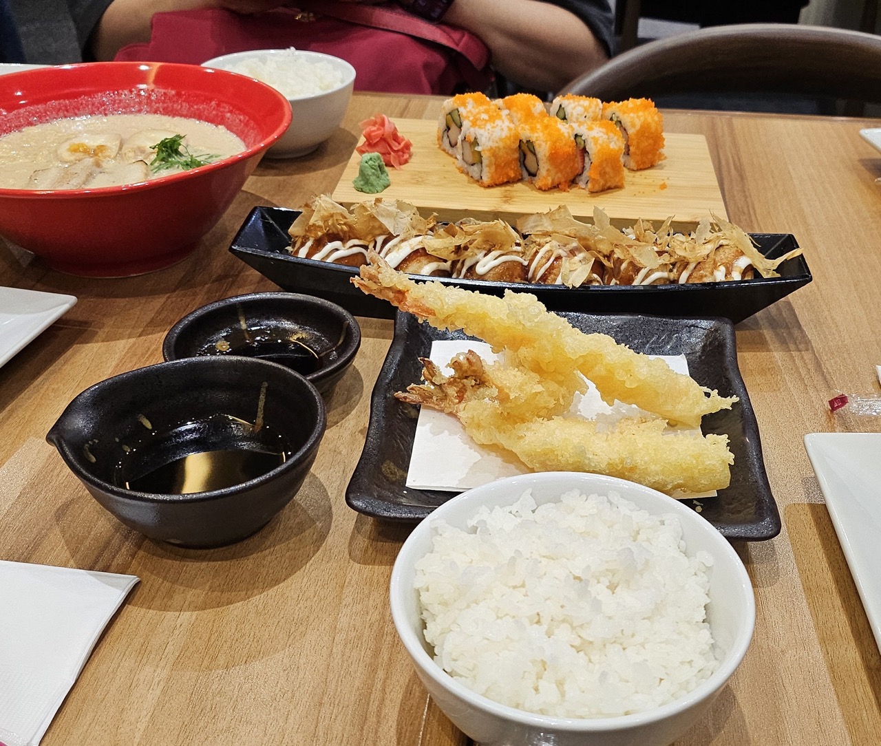 Picture of some ramen, sushi, takoyaki(?), shrimp tempura, and rice.